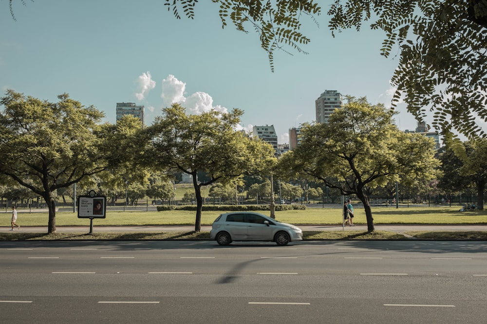 a white car parked on the side of a road