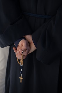 A group gathered in prayerful reflection holding rosaries.