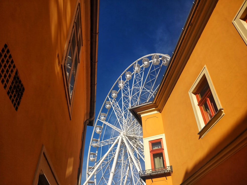 a large ferris wheel sitting next to a tall building