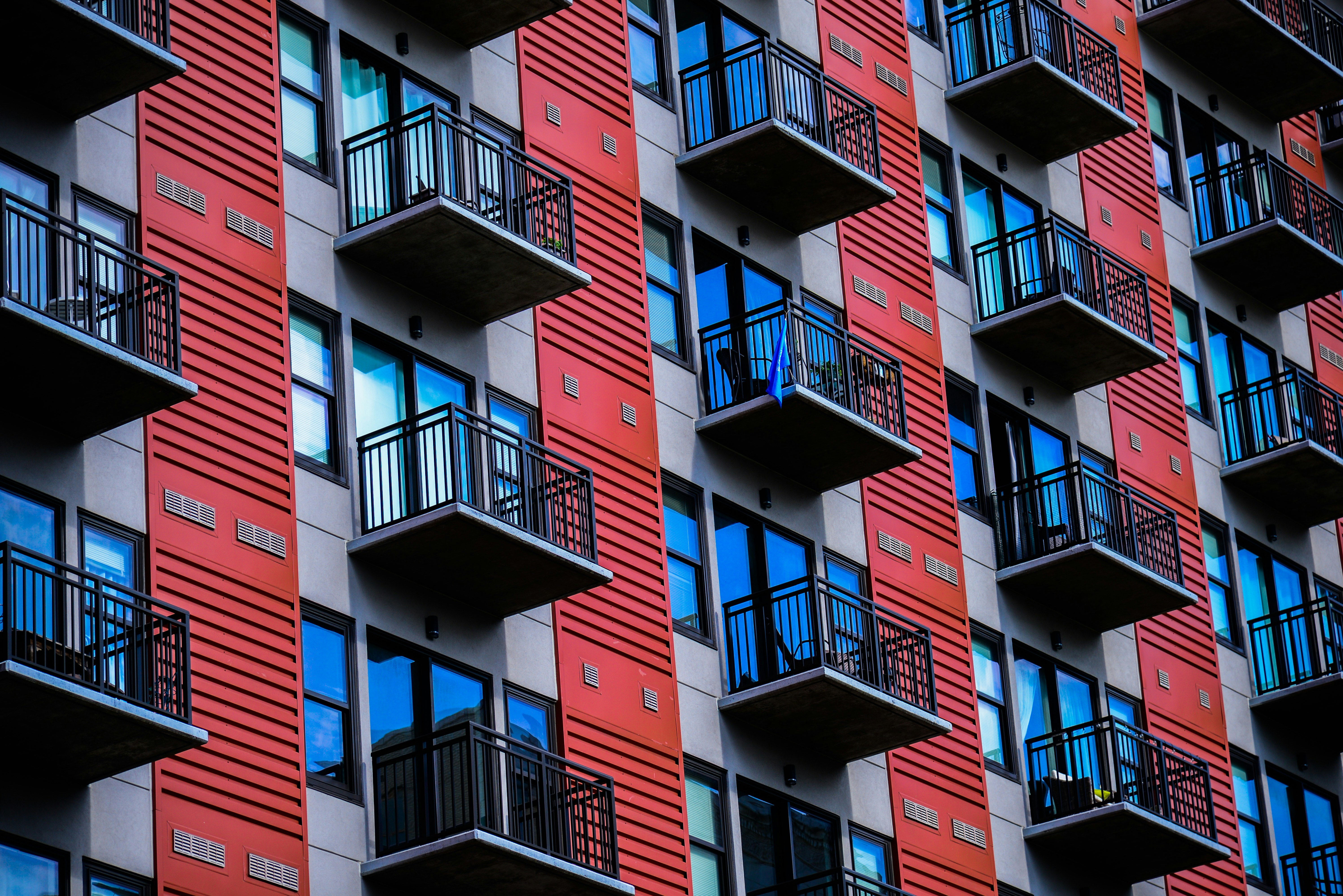 a tall red building with balconies and balconies
