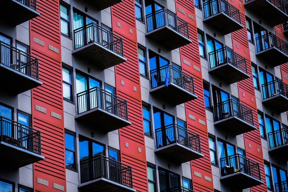 a tall red building with balconies and balconies