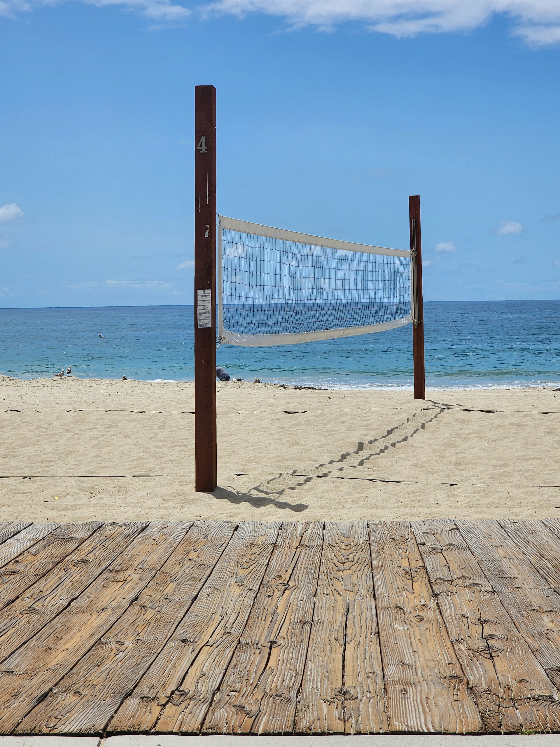 woman wearing yellow long-sleeved dress under white clouds and blue sky during daytime
