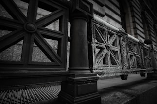 Close-up of intricately designed wrought iron fence with artistic patterns under natural light