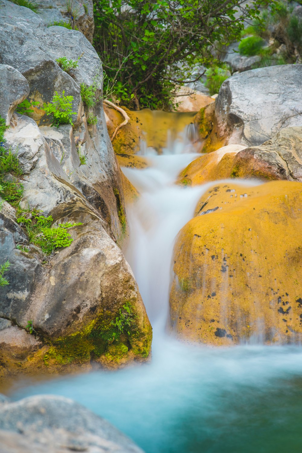 a stream of water running between two large rocks