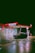 A brightly lit gas station at night with a Texaco sign and a convenience store called StarMart. A dark-colored car is parked near the gas pumps. The ground is wet, reflecting the lights from the station, creating a moody and cinematic atmosphere.