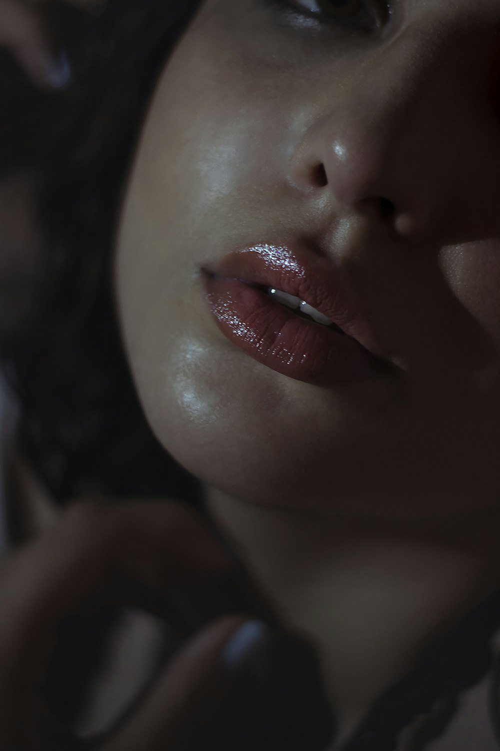 a close up of a woman's face with a cigarette in her mouth