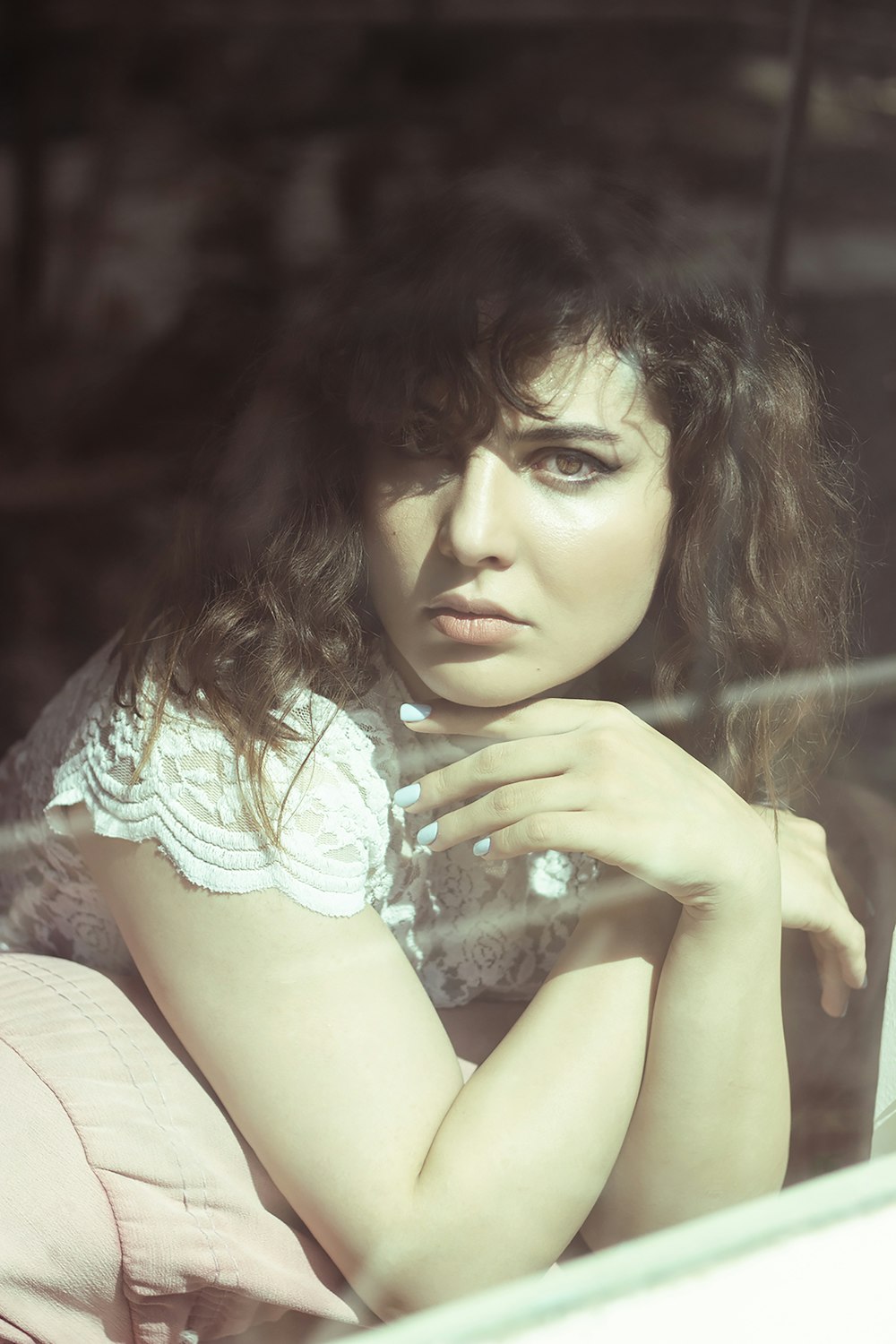 a woman sitting in a car looking out the window