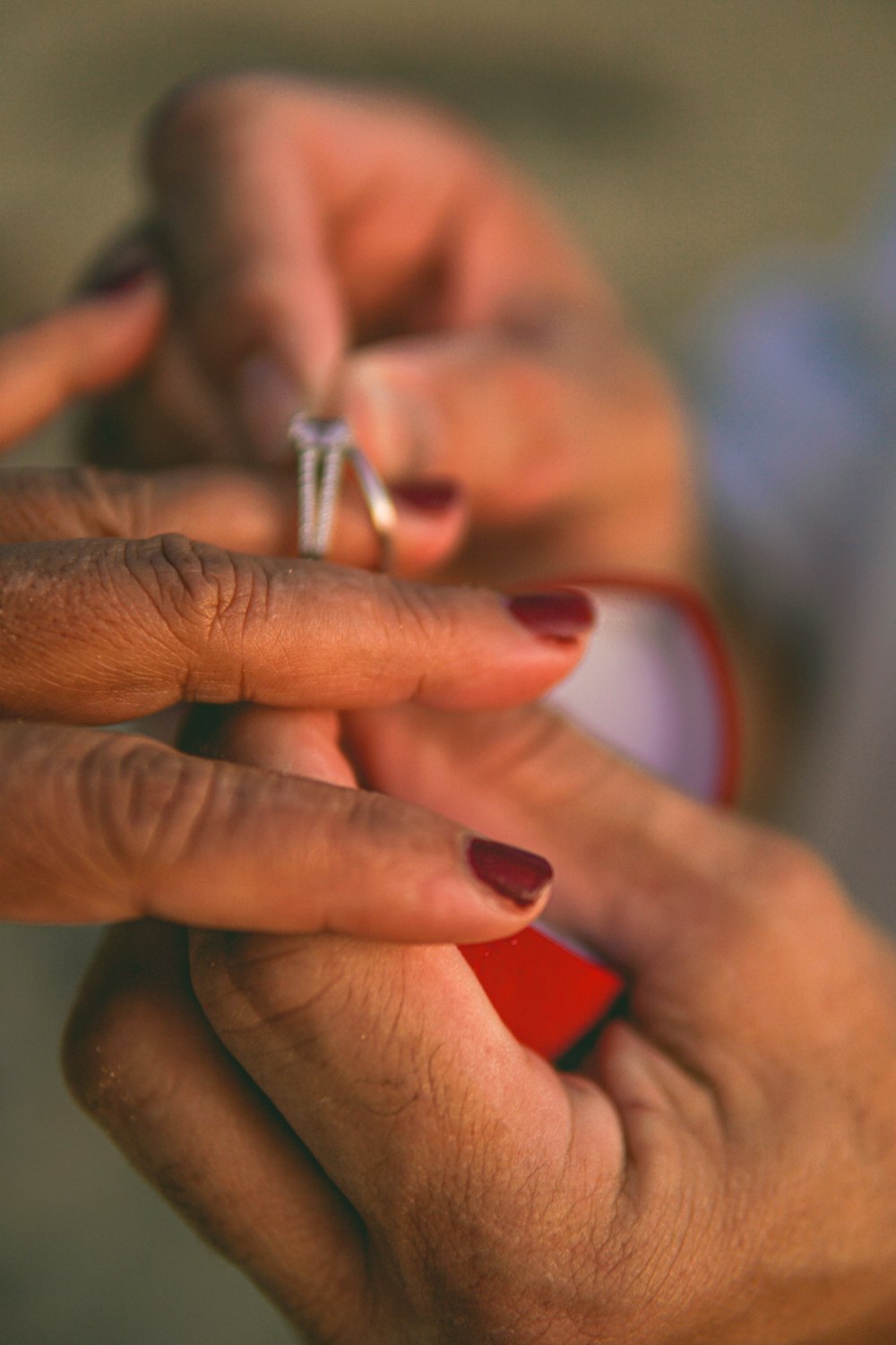 a woman holding a ring in her hands