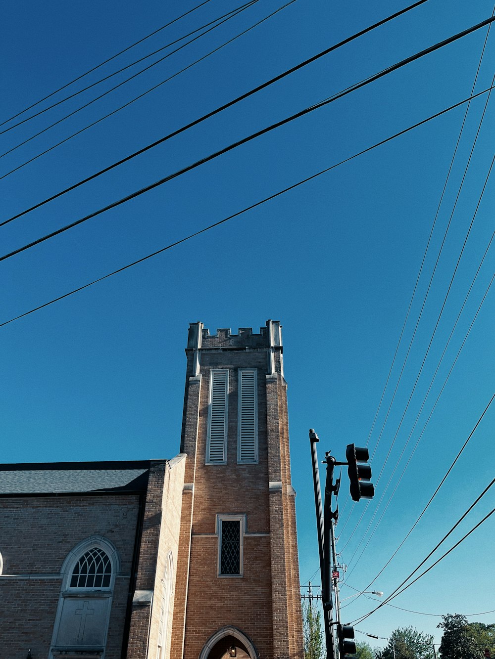 a tall brick building with a clock on the front of it