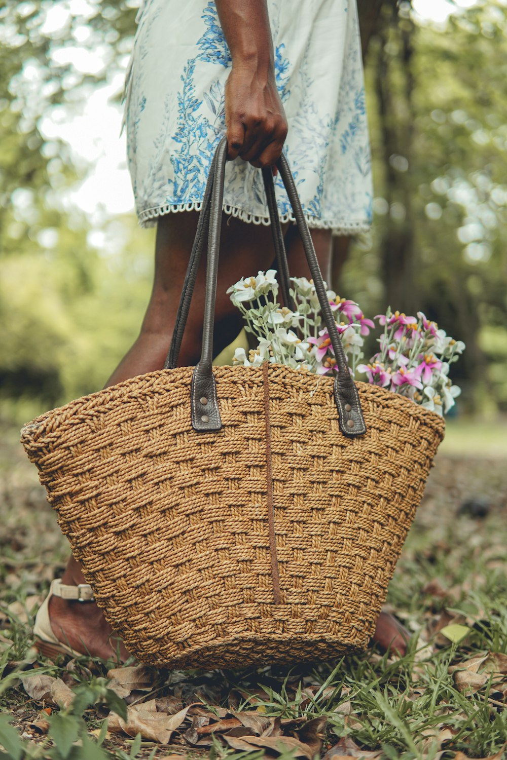 a woman holding a basket with flowers in it