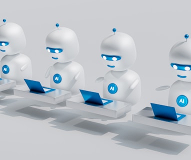 a group of white robots sitting on top of laptops