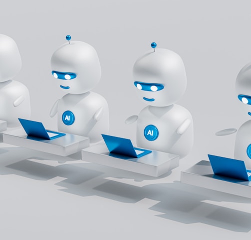 a group of white robots sitting on top of laptops