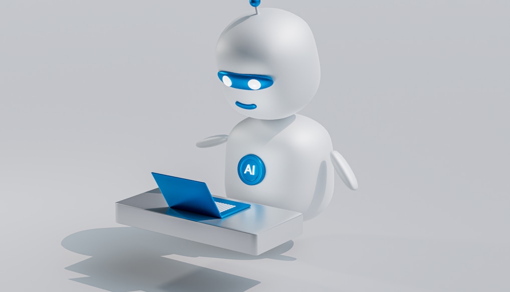 a white robot with blue eyes and a laptop