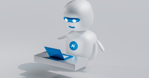 a white robot with blue eyes and a laptop
