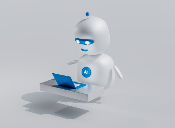 A small, round robot with a smooth white surface and blue accents operates a blue laptop on a sleek, floating platform. The robot has glowing eyes and an antenna on its head, with an 'AI' emblem on its front.