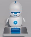 A small, white humanoid robot with blue accents, including eyes, mouth, and a circular badge with the letters 'AI' on its chest, is positioned in front of a blue laptop on a metallic surface. The robot has a simple, smooth design with two cylindrical arms and a small antenna on top.