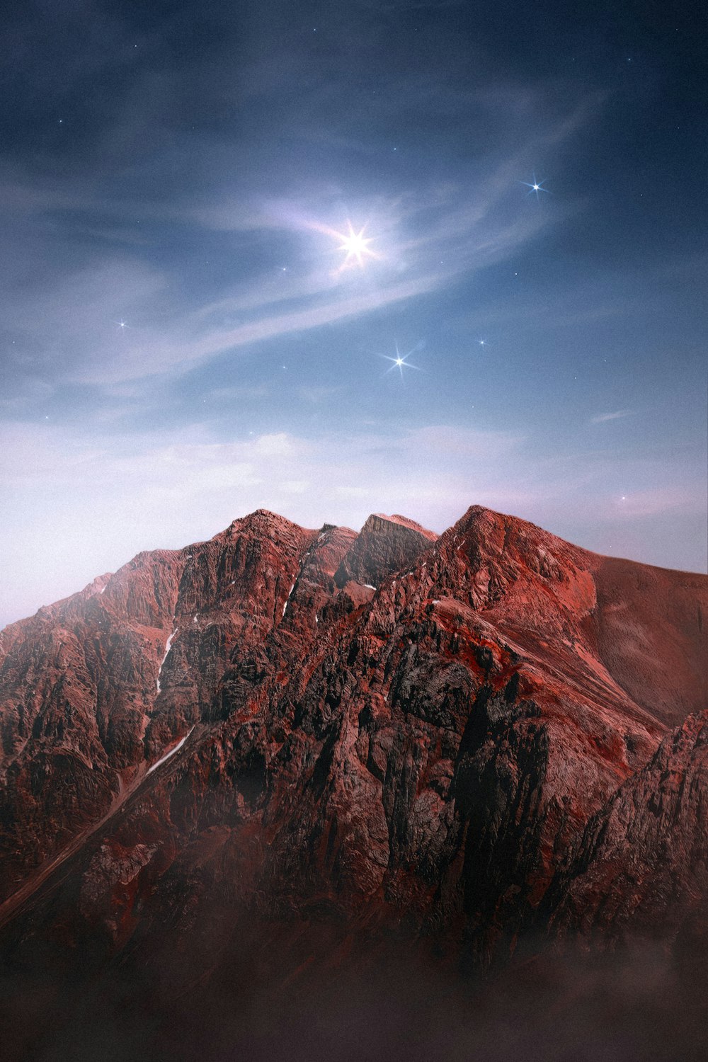 a view of a mountain with a star in the sky