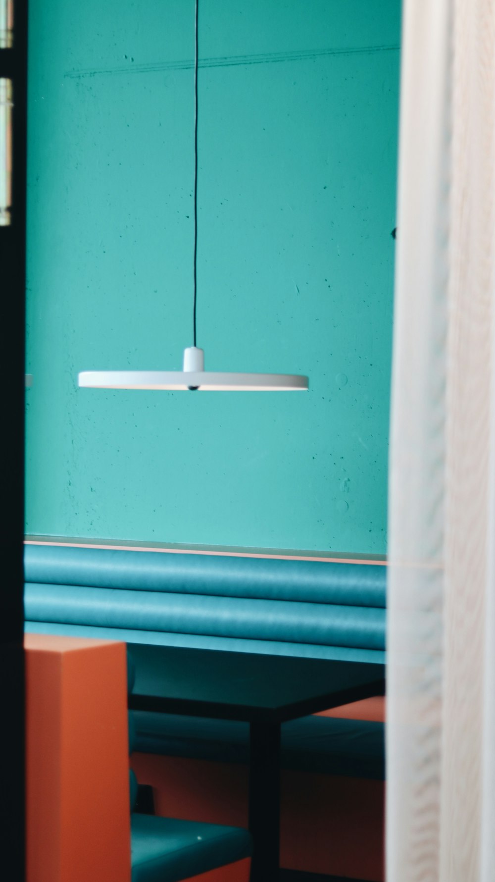 a room with a blue wall and a light fixture