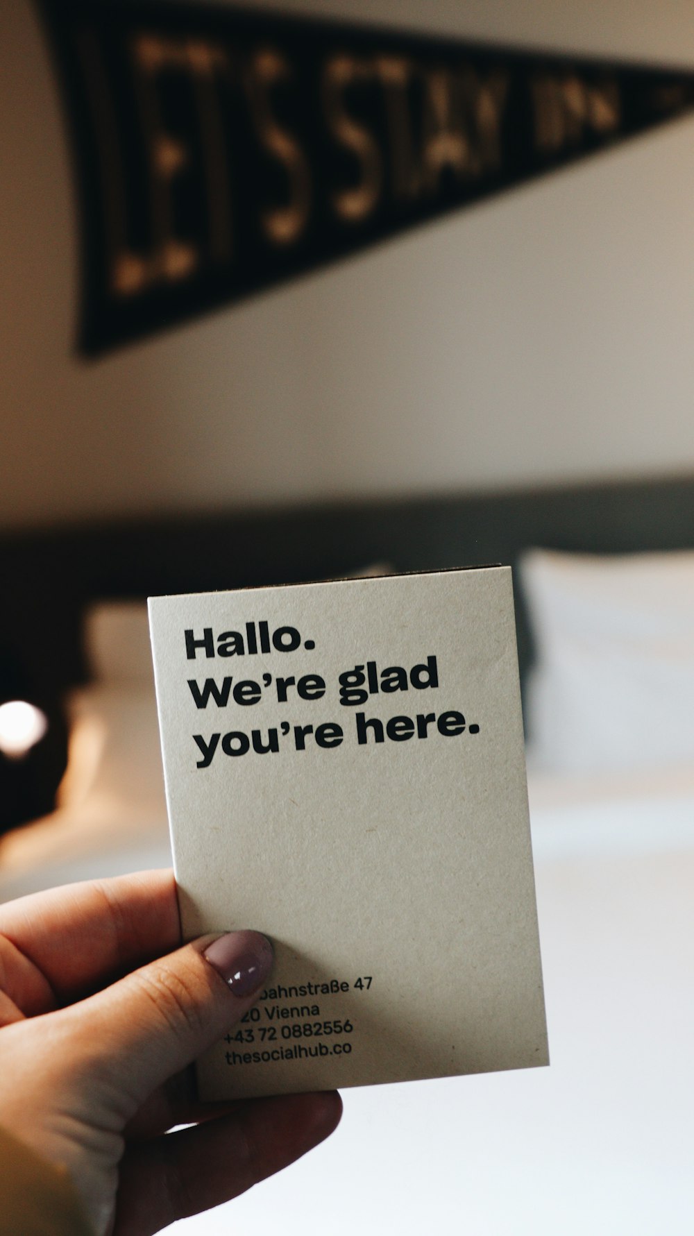a person holding a piece of paper that says hello, we're glad you