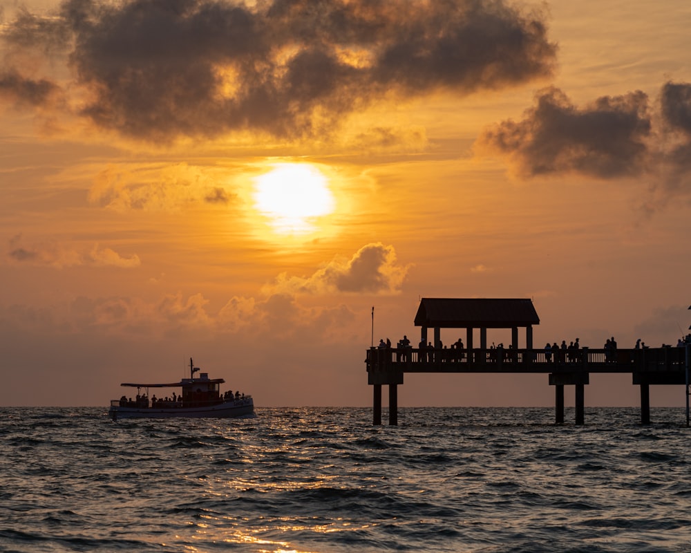 a boat is in the water near a pier