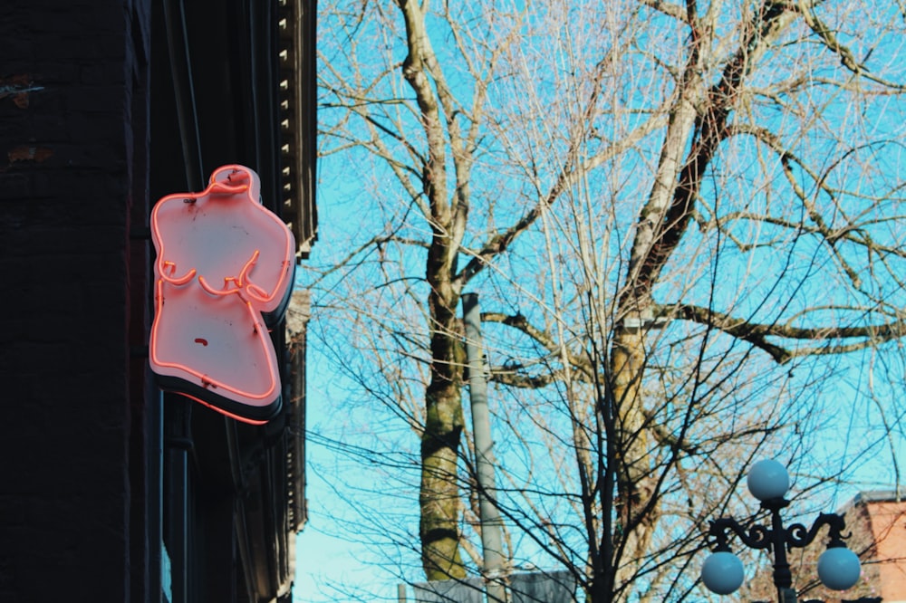 a neon sign hanging from the side of a building