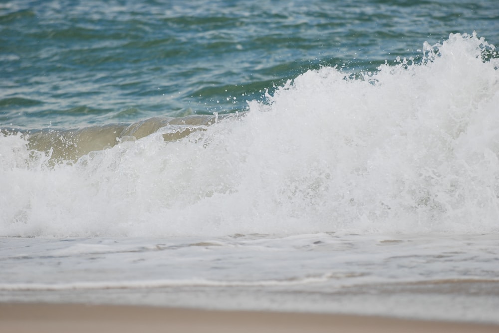 a man riding a surfboard on top of a wave in the ocean