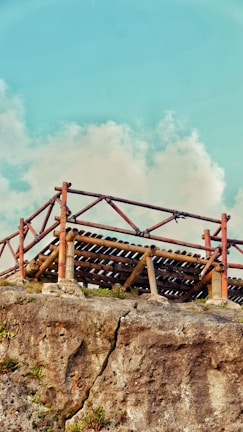 A panoramic view of a sprawling survival base built with intricate wooden and stone structures.