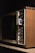 A vintage television set with wood paneling and various manual adjustment knobs and sliders for volume, contrast, brightness, and vertical hold on the side.