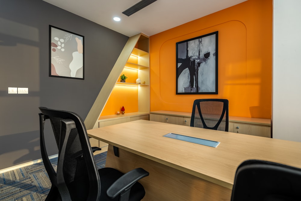 an office with a desk, chair, and pictures on the wall