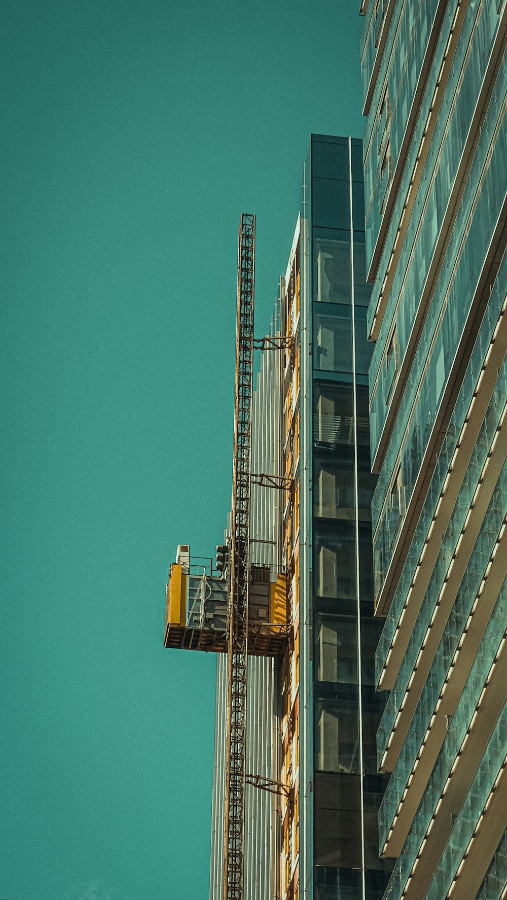 a crane is attached to the side of a tall building