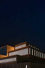 Night view of a creative arts building with illuminated geometric shapes