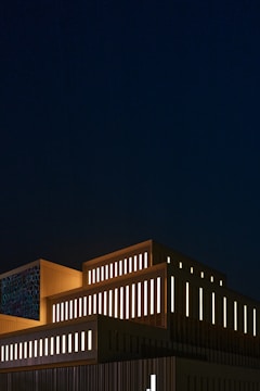 Night view of a creative arts building with illuminated geometric shapes