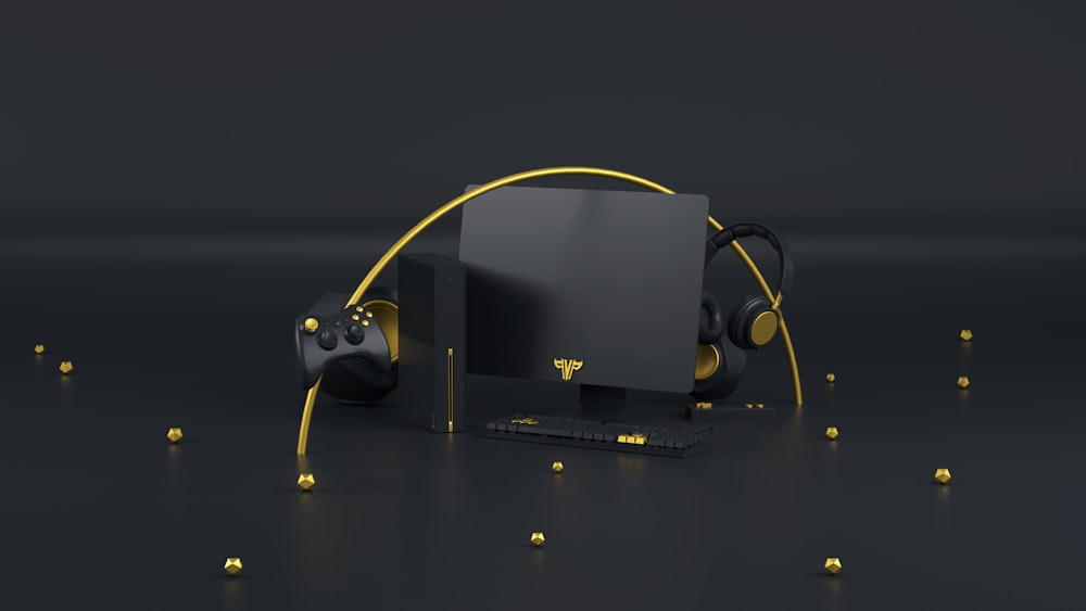 a black computer with yellow headphones and a monitor