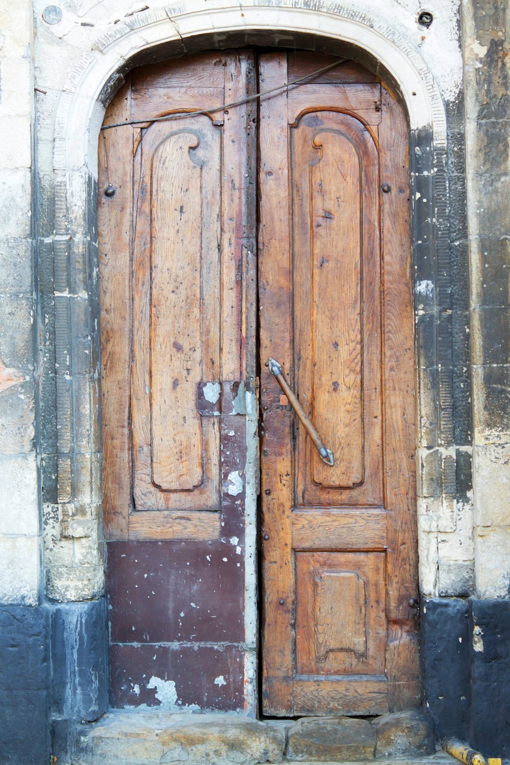 a large wooden door with a metal handle