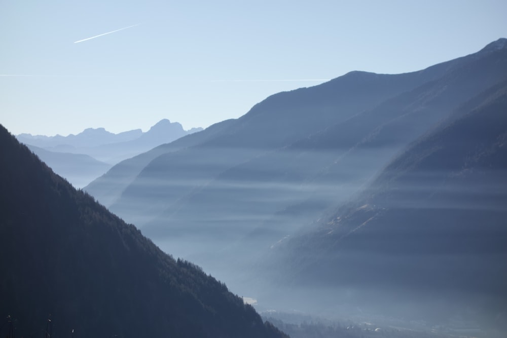 a view of a valley with mountains in the background