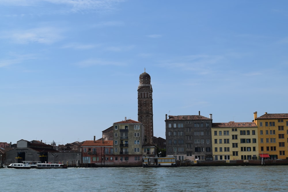 a clock tower in the middle of a body of water