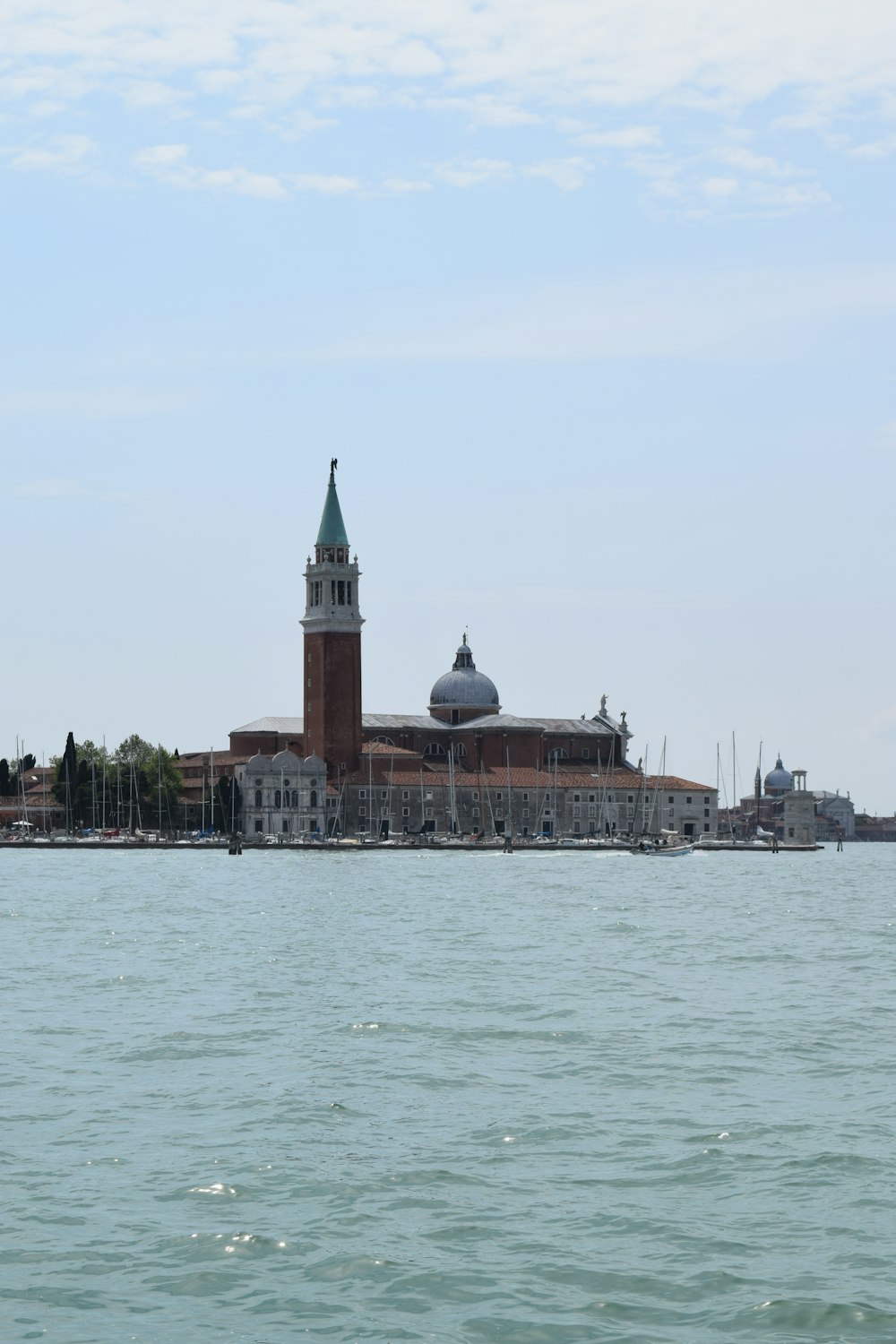 a large body of water with a large building in the background