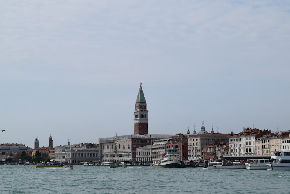 a large body of water with a clock tower in the background