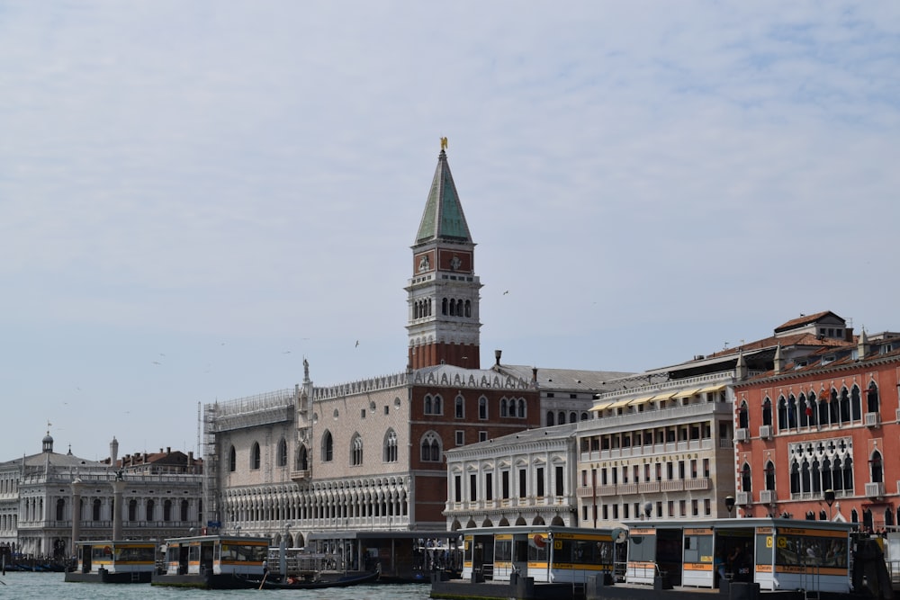 a large building with a tower next to a body of water