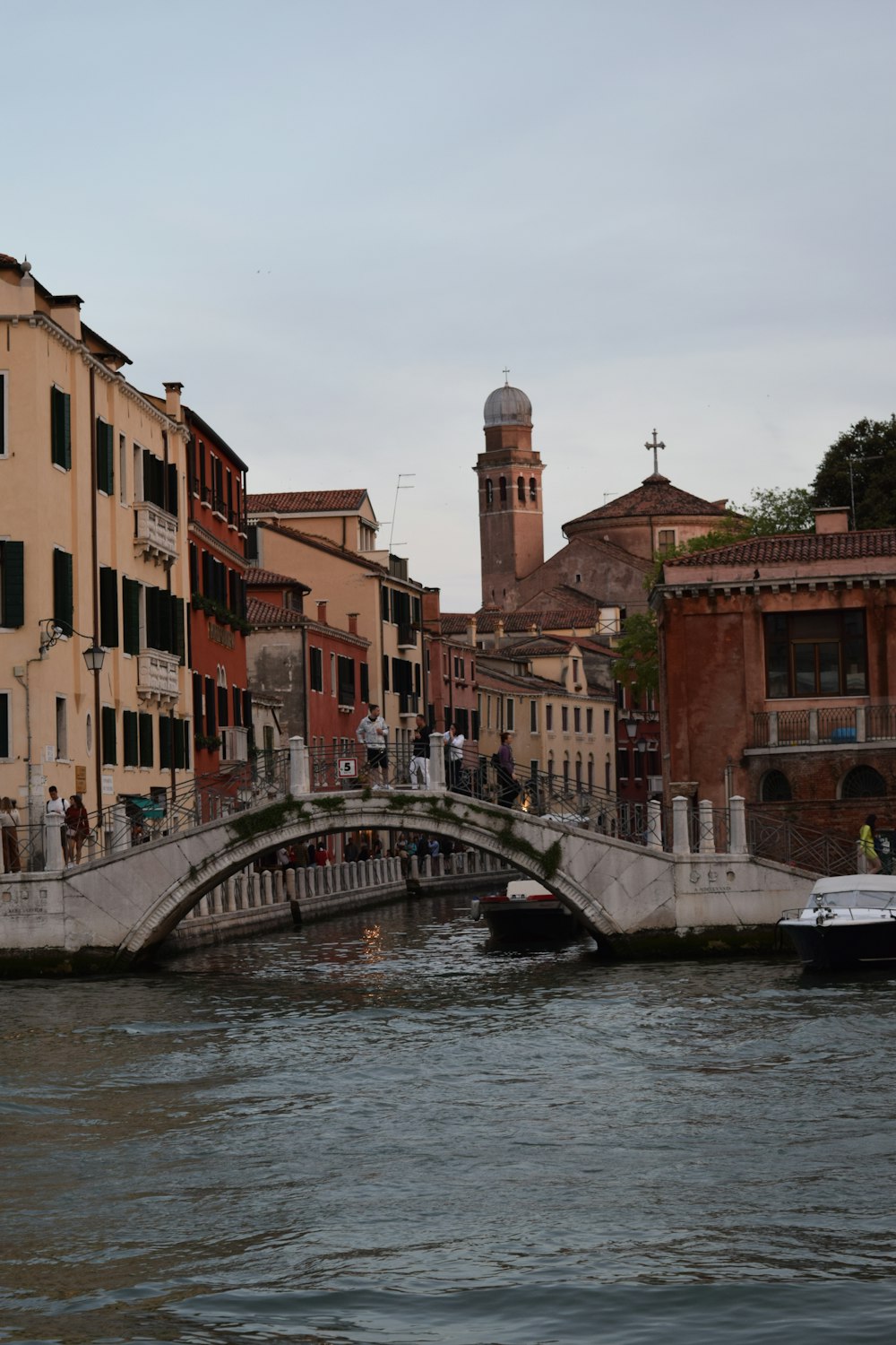 a bridge over a body of water with buildings in the background