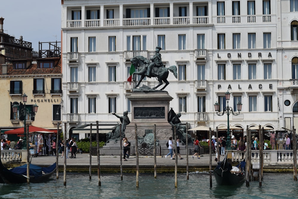 a statue of a man on a horse in front of a building