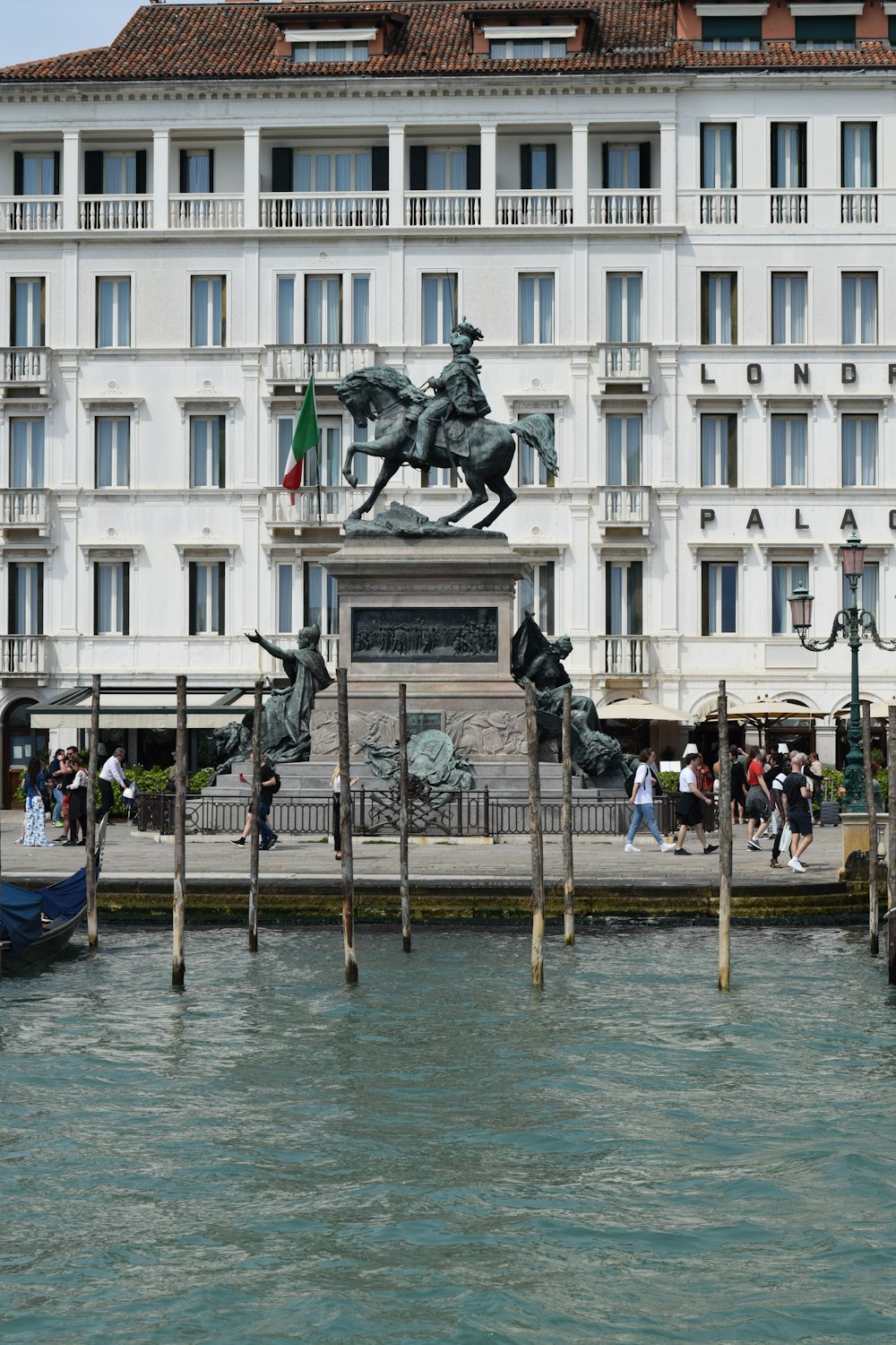 a statue of a man on a horse in front of a building