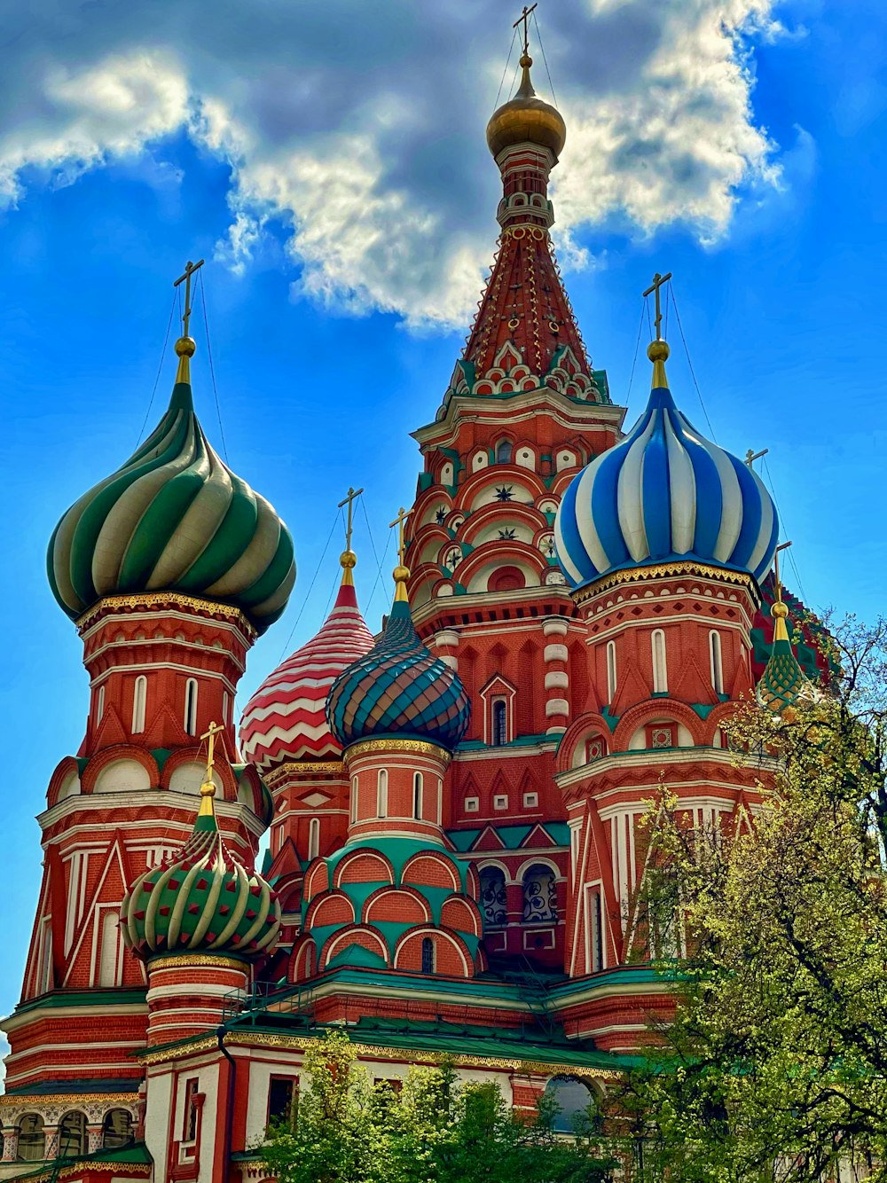 a large red and white building with a blue sky in the background