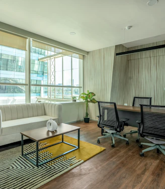 A sleek, minimalist Parisian office space with soft natural light and subtle gold accents.
