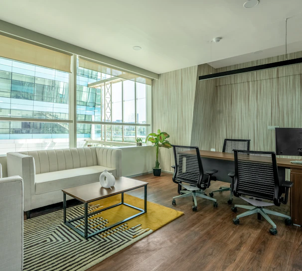 A sleek, minimalist Parisian office space with soft natural light and subtle gold accents.