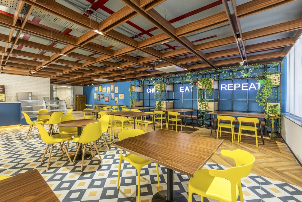 a restaurant with yellow chairs and a checkered floor