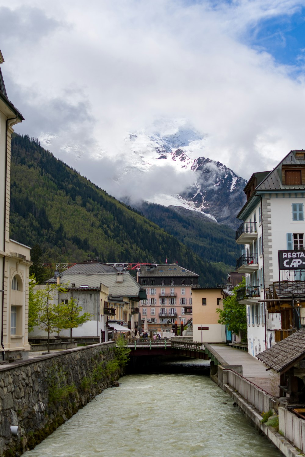 a river running through a town surrounded by mountains