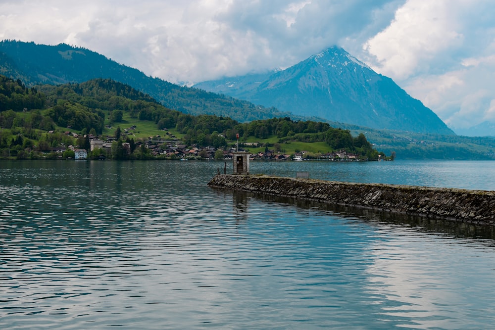 a body of water with a mountain in the background