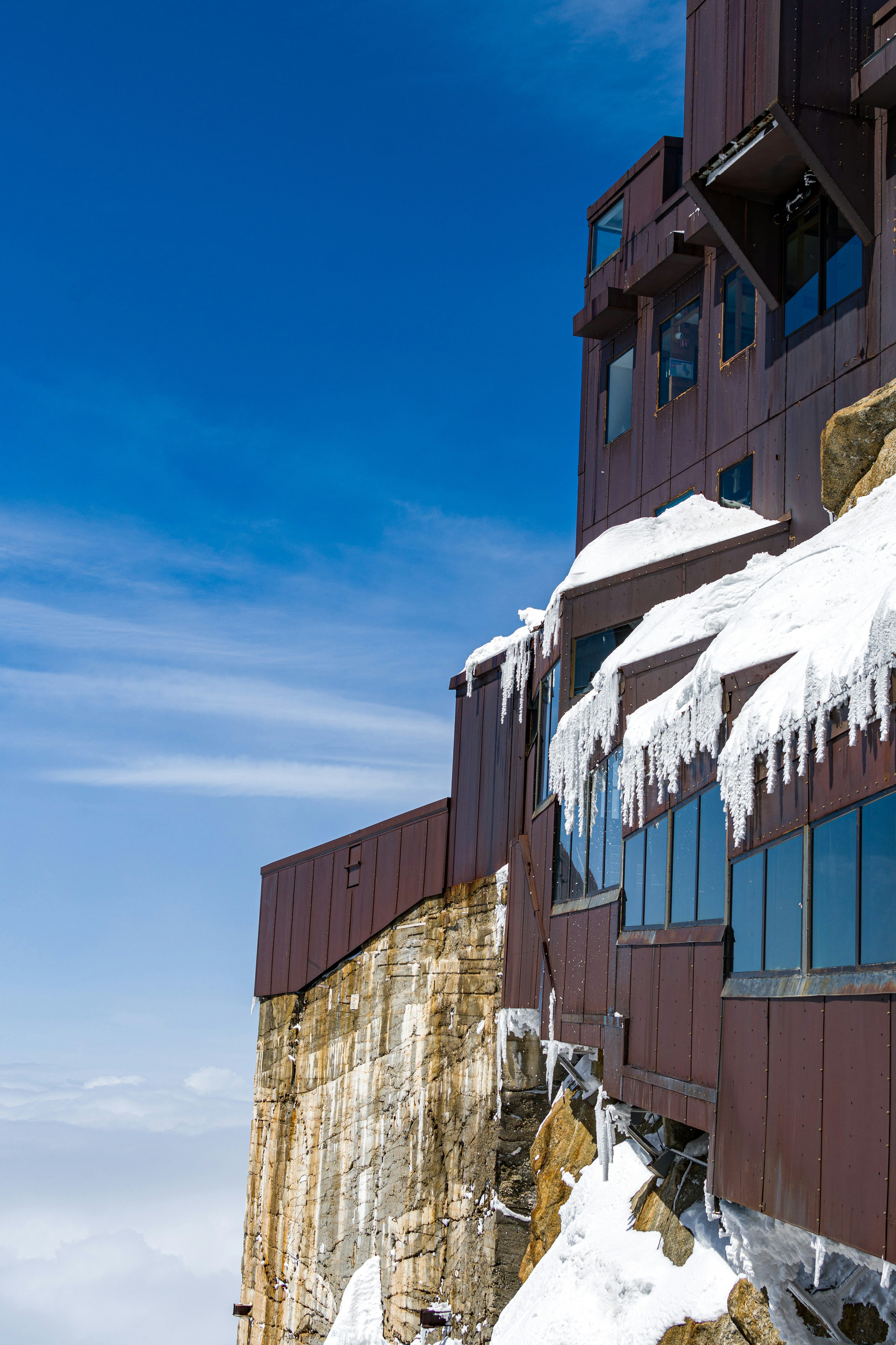 A very tall building covered in ice and snow photo – Free Mountains ...