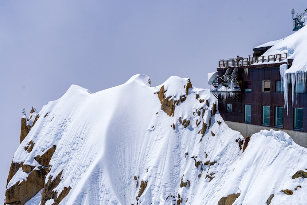 a building on top of a mountain covered in snow